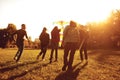 Young people with a kite run on the grass in the park. Royalty Free Stock Photo