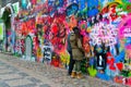 Young people leave inscription on famous John Lennon Wall near Kampa Island in Prague, Czech Republic