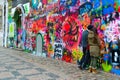 Young people leave inscription on famous John Lennon Wall near Kampa Island in Prague, Czech Republic