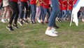 Young people legs repeating synchronous movement dance. Gimbal motion