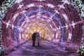 Young people in lit with colored lights the tunnel to Pushkinskaya square, Moscow