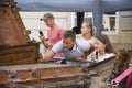 Young people are looking at the broken tank T 72 Royalty Free Stock Photo