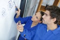 Young people looking at exploded view drawing