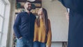 young people looking at interior of house they are going to buy and discussing it with real estate agent. Happy couple Royalty Free Stock Photo