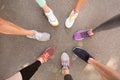 Young people making circle and showing their sports shoes outdoors Royalty Free Stock Photo