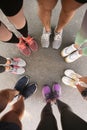 Young people making circle and showing their sports shoes outdoors Royalty Free Stock Photo