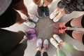 Young people making circle and showing their sports shoes outdoors Royalty Free Stock Photo