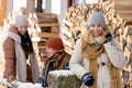 Young people outside winter cottage wooden logs