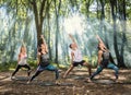 Young people perform stretching exercises in forest