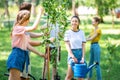 young people planting new trees and volunteering in park