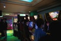 Young people play Pop`n Music Konami arcade