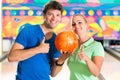 Young people playing bowling and having fun