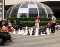 Young people playing street chess near Vancouver`s Pacific Centre. BC, Canada Royalty Free Stock Photo