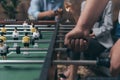 Young people playing foosball indoors Royalty Free Stock Photo