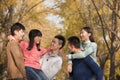 Young people playing piggyback in park Royalty Free Stock Photo