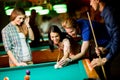 Young people playing pool Royalty Free Stock Photo