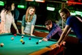 Young people playing pool Royalty Free Stock Photo