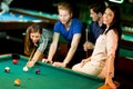 Young people playing pool Royalty Free Stock Photo