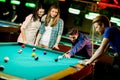 Young people playing pool Royalty Free Stock Photo