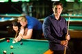 Young people playing pool Royalty Free Stock Photo