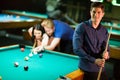 Young people playing pool Royalty Free Stock Photo