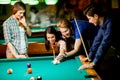 Young people playing pool Royalty Free Stock Photo