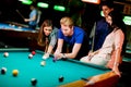 Young people playing pool Royalty Free Stock Photo