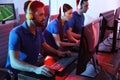 Young people playing video games on computers. Esports tournament Royalty Free Stock Photo