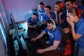 Young people playing video games on computers. Esports tournament