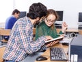 Young people reading book and using pc in library Royalty Free Stock Photo