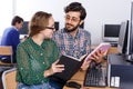 Young people reading book and using pc in library Royalty Free Stock Photo