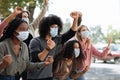 Young people in protective masks attending demonstration on the street