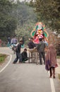 Young people pump up a wheel at the vehicle with Sarasvati.