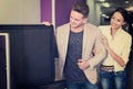 Young people purchasing flat screen television set Royalty Free Stock Photo