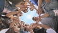 Young people putting their hands in circle on sky background. Unity concept. Royalty Free Stock Photo