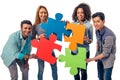 Young people with puzzles Royalty Free Stock Photo