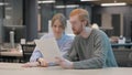 Young People Reading Documents in Office Royalty Free Stock Photo