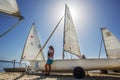 Young people are ready to start riding on small sailboats