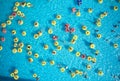 Young people relax in swimming pool at bubble bath.