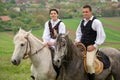 Young people riding on beautiful horses , having fun in summer time , Romania countryside