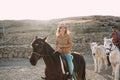 Young people riding bitless horses inside corral - Wild couple having fun in equestrian ranch  - Training, culture, passion, Royalty Free Stock Photo