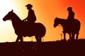 Young people riding horses at sunset time - Silhouette Horseback travel people having fun exploring wild nature Royalty Free Stock Photo