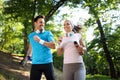 Young people running outdoors. Couple or friends of runners exercising in park