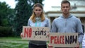 Young people showing slogans for world peace, against nuclear weapon, terrorism Royalty Free Stock Photo