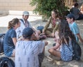 Young people sitting in a circle and talking with a girl soldier. Taglit - Birthright Israel program. Study trip in Akko, the city