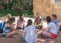 Young people sitting in a circle and talking with a soldier. Taglit - Birthright Israel program. Study trip in Akko, Israel