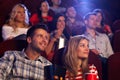 Young people sitting at movie theater Royalty Free Stock Photo