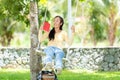 Young people sitting swing and relax after working on laptop at nature garden home Royalty Free Stock Photo