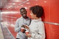 young people with smartphones and takeaway coffee waiting for the subway train . Royalty Free Stock Photo