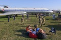 Young people soldiers, pilots and stewardesses playing volleyball, landed aircraft on a background. Kyiv, Ukraine